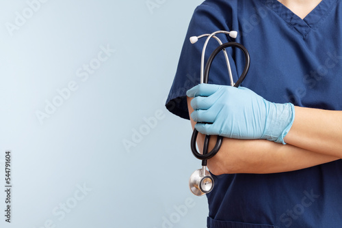 Canvastavla Female doctor in uniform with stethoscope on a blue background