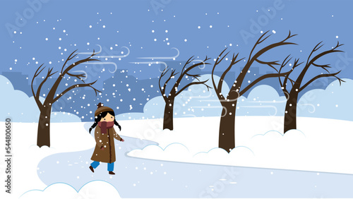 A girl walks in a snowstorm among the trees