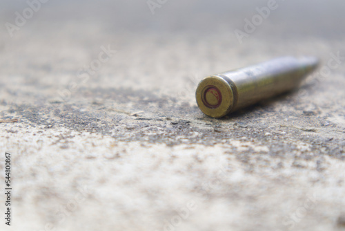 Bullet on ground for inspection of crime evidence.