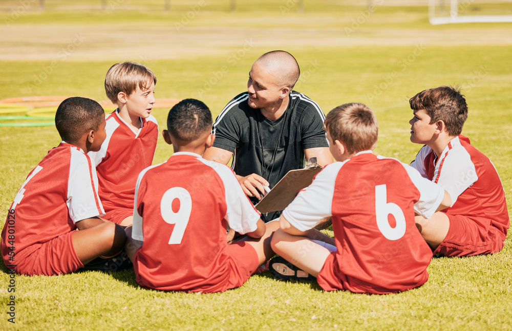 Obraz premium kids, soccer and team coach planning training with clipboard on soccer field for sport competitiion together. Athlete children, teamwork and sit on grass before football match or workout outdoors