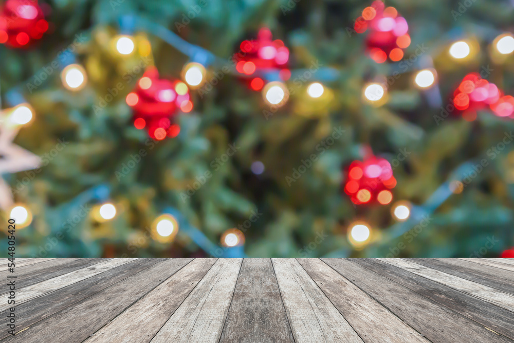 Empty wood table top with blur Christmas tree with bokeh light background Empty wood table top with blur Christmas tree with bokeh light background