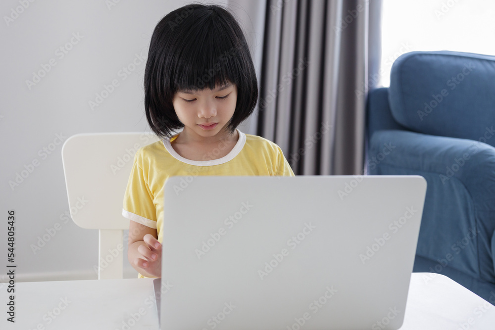 little asian girl student study online using laptop computer at home little asian girl student study online using laptop computer at home