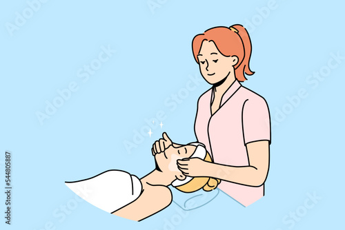 Beautician make face massage to female client in beauty salon. Cosmetologist do masks or facial procedures to woman patient in spa. Skincare routine. Vector illustration. 