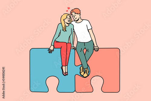 Happy couple sitting on jigsaw puzzles hugging. Smiling man and woman embrace find love together. Relationship and affection. Vector illustration. 