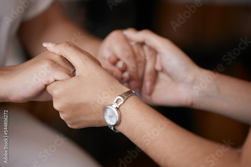 Friends, support and trust with people holding hands in care, compassion or love inside closeup from above. Help, together and unity with a woman and friend hand in hand for emotional support