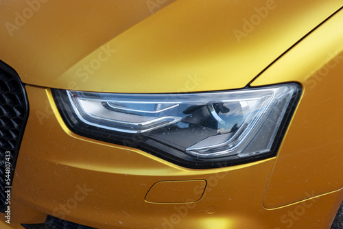 Front headlights of the luxury golden car