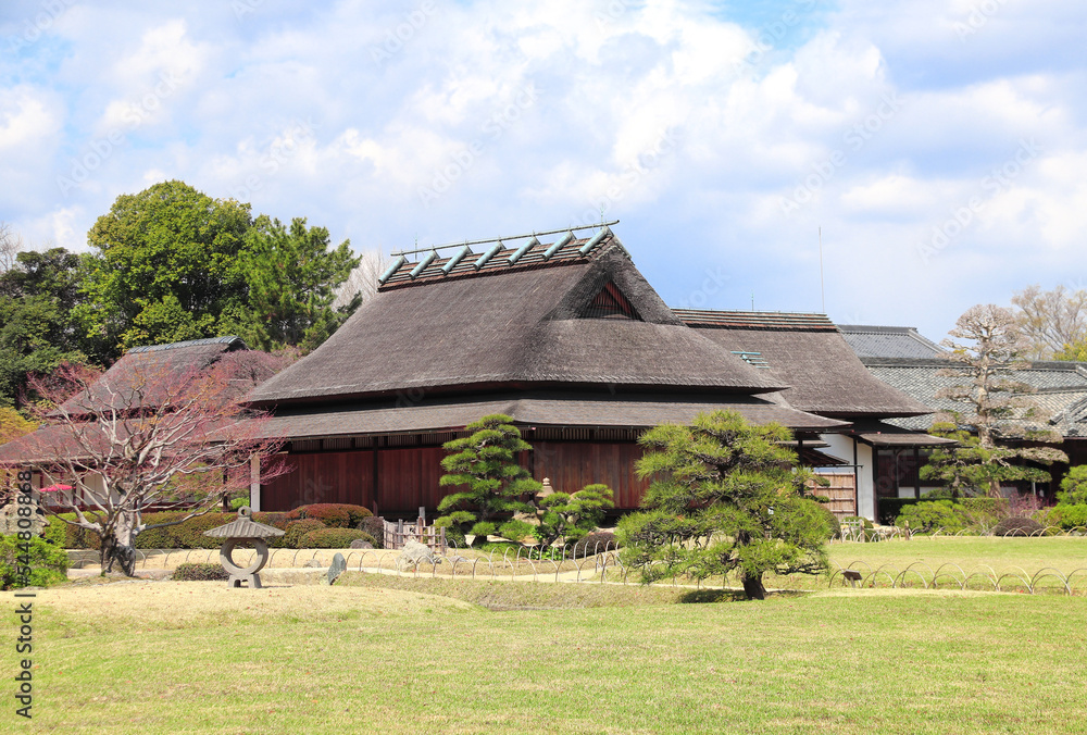 Ancient pavilion and stone lantern in Koishikawa Korakuen garden, Okayama, Japan Ancient pavilion and stone lantern in Koishikawa Korakuen garden, Okayama, Japan