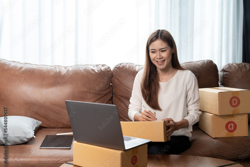 Portrait asian woman packing box. small business owner in home office, online sell marketing delivery, SME e-commerce telemarketing Startup small business entrepreneur concept Portrait asian woman packing box. small business owner in home office, online sell marketing delivery, SME e-commerce telemarketing Startup small business entrepreneur concept