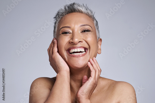 Skincare, makeup and senior woman excited about facial health, wellness and beauty against a grey mockup studio background. Smile, happy and face portrait of an elderly model for dermatology