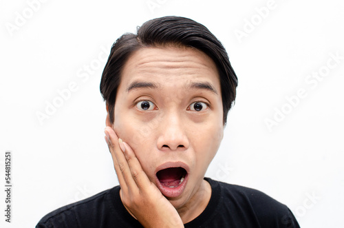 headshot of shocked, surprised, amazed young asian man in black tshirt isolated over white