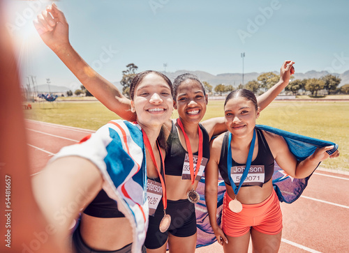 Fototapeta Naklejka Na Ścianę i Meble -  Selfie, medal and friends with a British flag after running, fitness and sports at a stadium. Collaboration, winning and women athlete group with a photo after achievement in sport or marathon