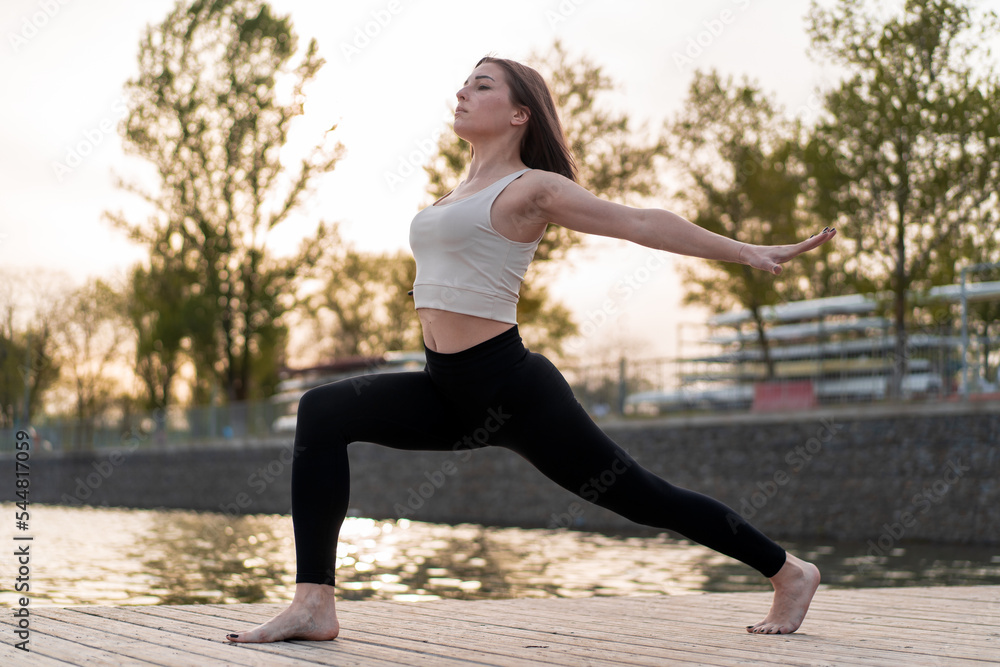 Young woman doing yoga by the lake Young woman doing yoga by the lake