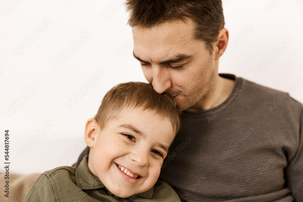 Portrait of father and son. Dad loves his boy. Positive family relationship. Young attractive man and his little kid spending time together. Respect and support, be a good example. Father's Day. Portrait of father and son. Dad loves his boy. Positive family relationship. Young attractive man and his little kid spending time together. Respect and support, be a good example. Father's Day.
