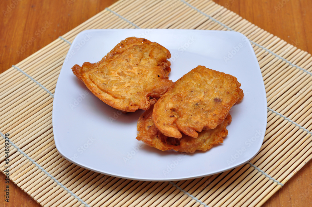 Fried tempeh flour ready to eat on a white plate Fried tempeh flour ready to eat on a white plate