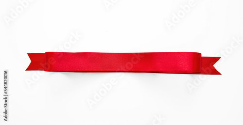 Red satin riibbon banner isolated on white, overhead. Christmas decoration, Valentine day . photo