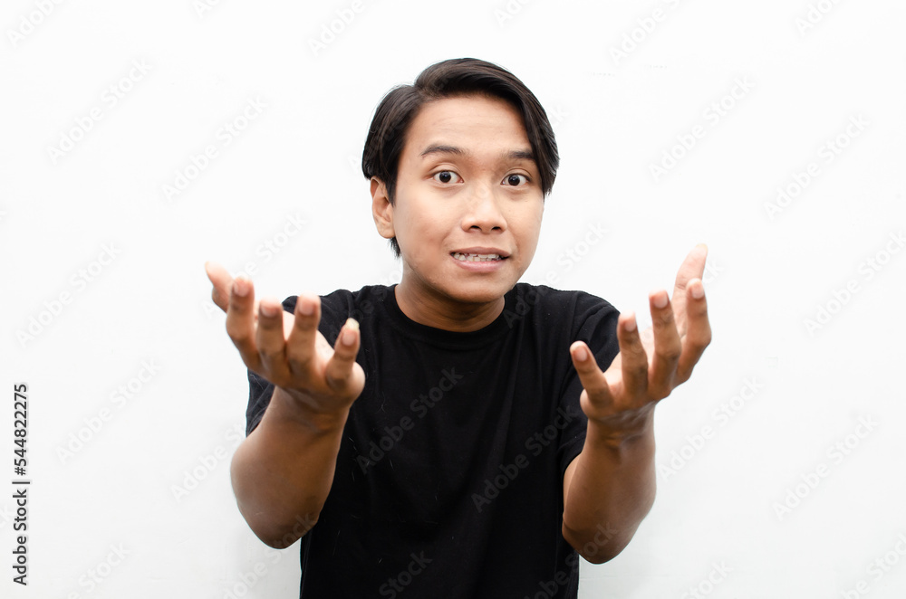 happy expressive asian young man with glasses shocked happily pointing finger to copy space offering something goods isolated over white background. billboard advertisment model concept. happy expressive asian young man with glasses shocked happily pointing finger to copy space offering something goods isolated over white background. billboard advertisment model concept.