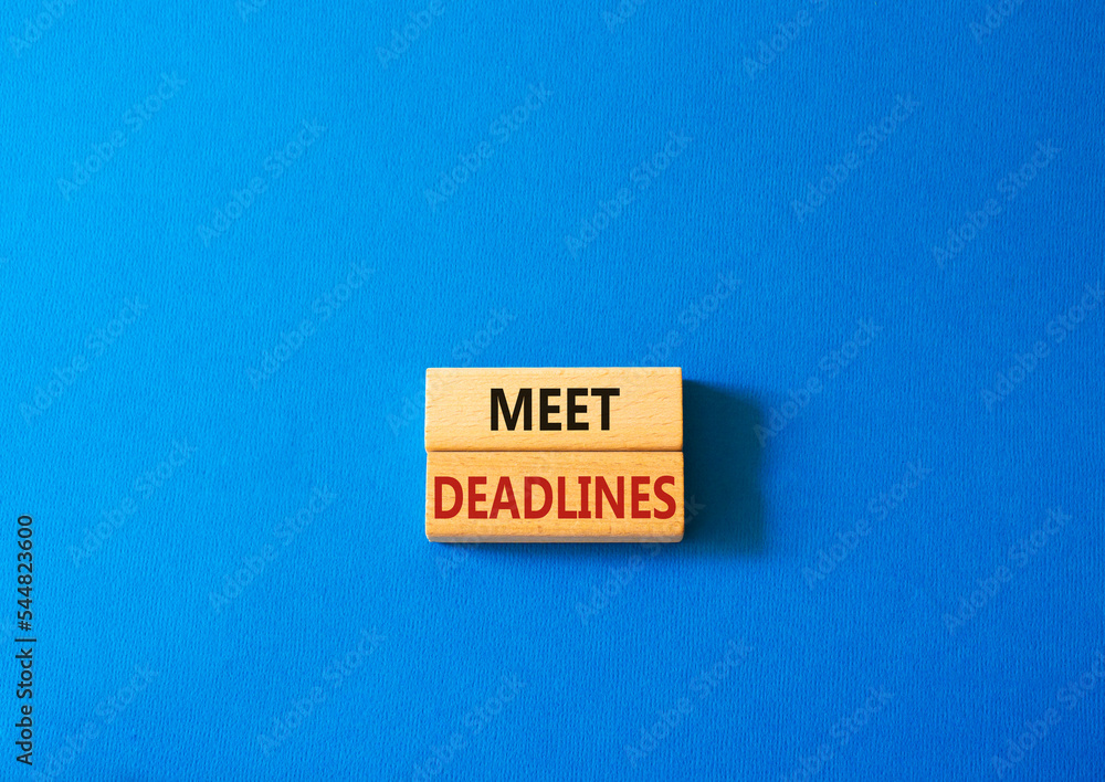 Meet Deadlines symbol. Concept word Meet Deadlines on wooden blocks. Beautiful blue background. Business and Meet Deadlines concept. Copy space Meet Deadlines symbol. Concept word Meet Deadlines on wooden blocks. Beautiful blue background. Business and Meet Deadlines concept. Copy space