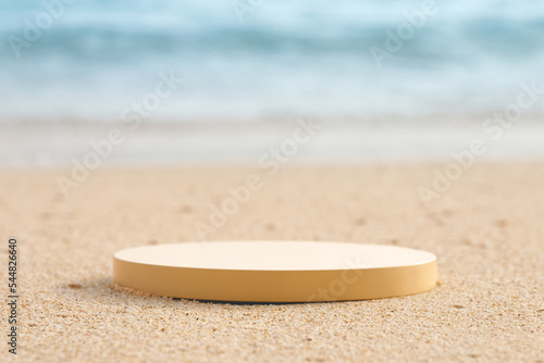 Empty round beige platform podium on the beach sand.