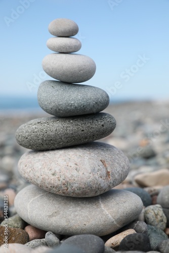 Stack of stones on beach against blurred background, closeup