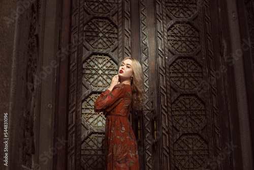 Young blonde woman in autumn city