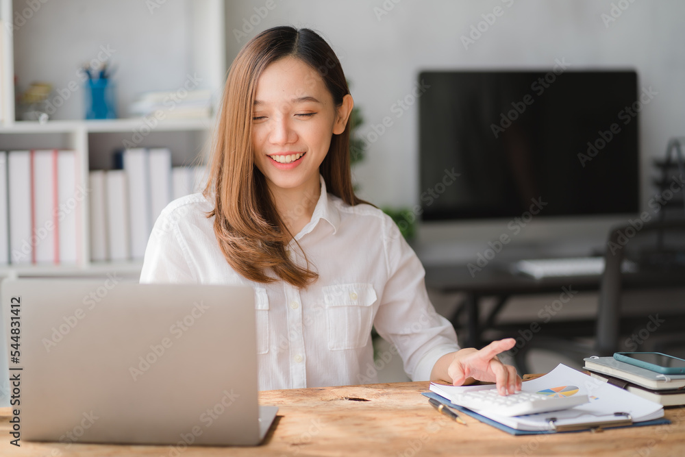 Young asian businesswoman beautiful charming smiling and using on mobile phone in the office. Young asian businesswoman beautiful charming smiling and using on mobile phone in the office.