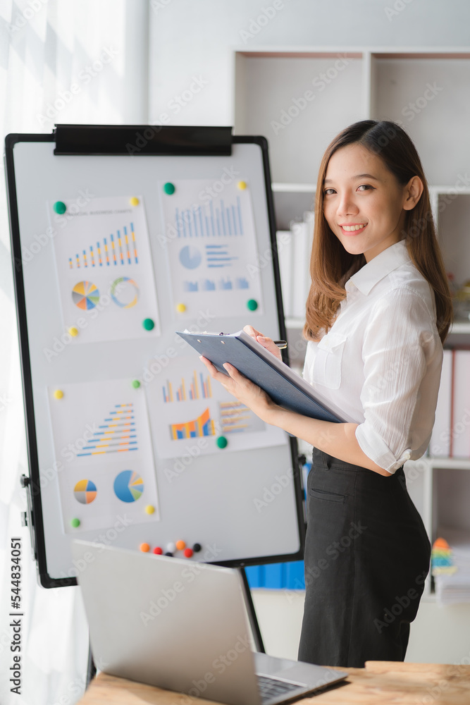 Beautiful Asian businesswoman standing confidently preparing for work. Beautiful Asian businesswoman standing confidently preparing for work.
