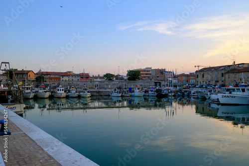 Senigallia, Italy: view of the harbor on the sunset over the yachts and boats. Urban view. City postcard. Marina at dusk