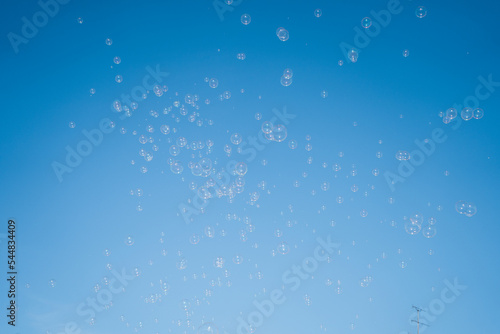 Canvas Print soap bubbles in the air with blue sky