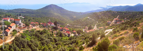 Velo Grablje, historic village on Hvar island in Croatia famous for lavender, vine and olive oil production. Panoramic banner image. Panorama, eerial view from mountain road. Bird view on old houses. photo