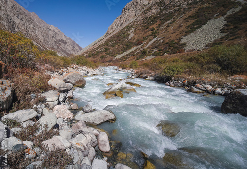 A small fast river high in the mountains. Tien Shan mountain landscape