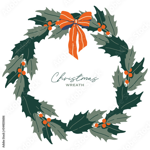 Christmas wreath with holly and red bow.