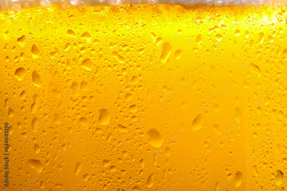 Glass of tasty cold beer with foam and condensation drops as background, closeup Glass of tasty cold beer with foam and condensation drops as background, closeup
