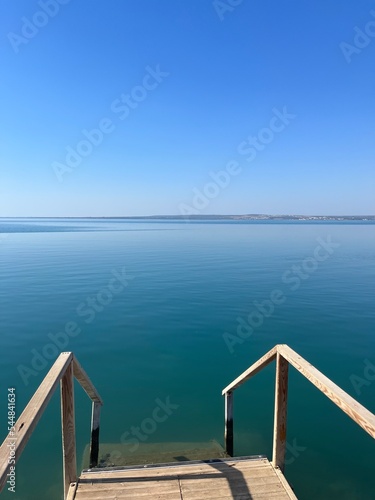 Blue sea horizon, clear blue sky and quiet sea surface © Oksana