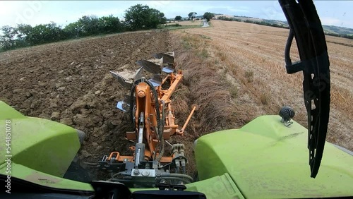 Pov tractor with furrow plow tool working the ground for agriculture