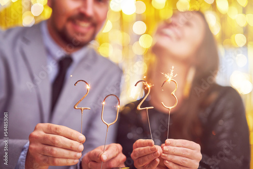 Photography Couple at new year eve party with 2023 sparklers