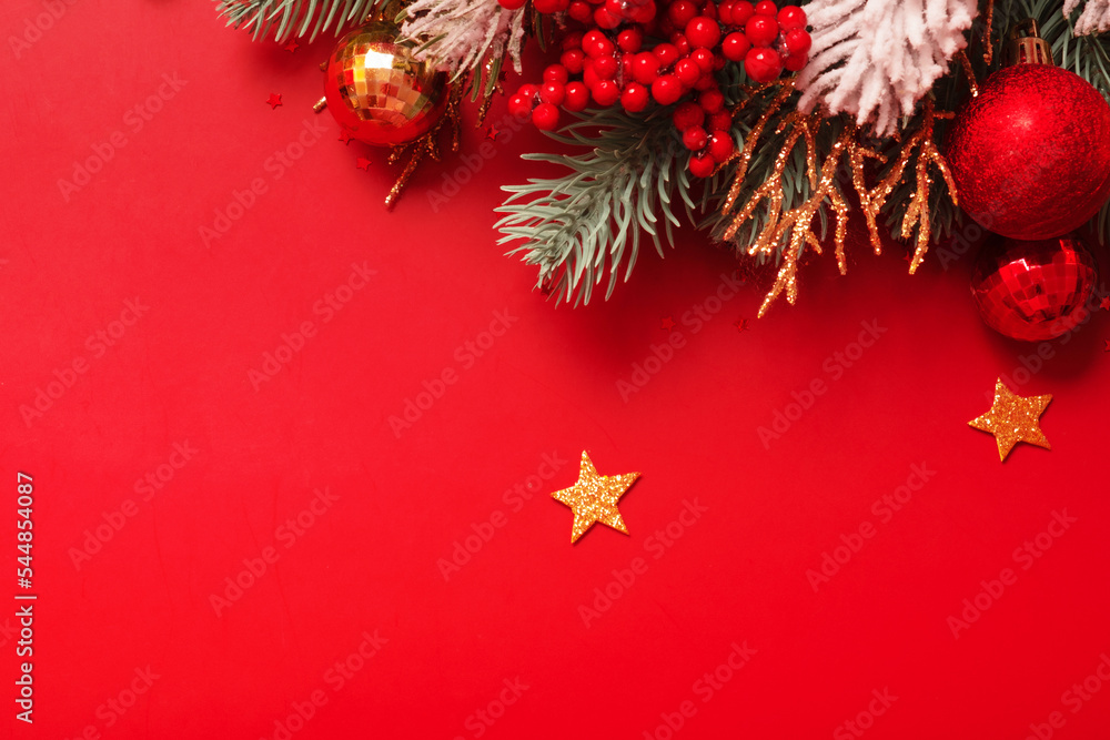Christmas decoration and pine tree on red background with copy space. New Year greeting card. Flat lay Christmas decoration and pine tree on red background with copy space. New Year greeting card. Flat lay