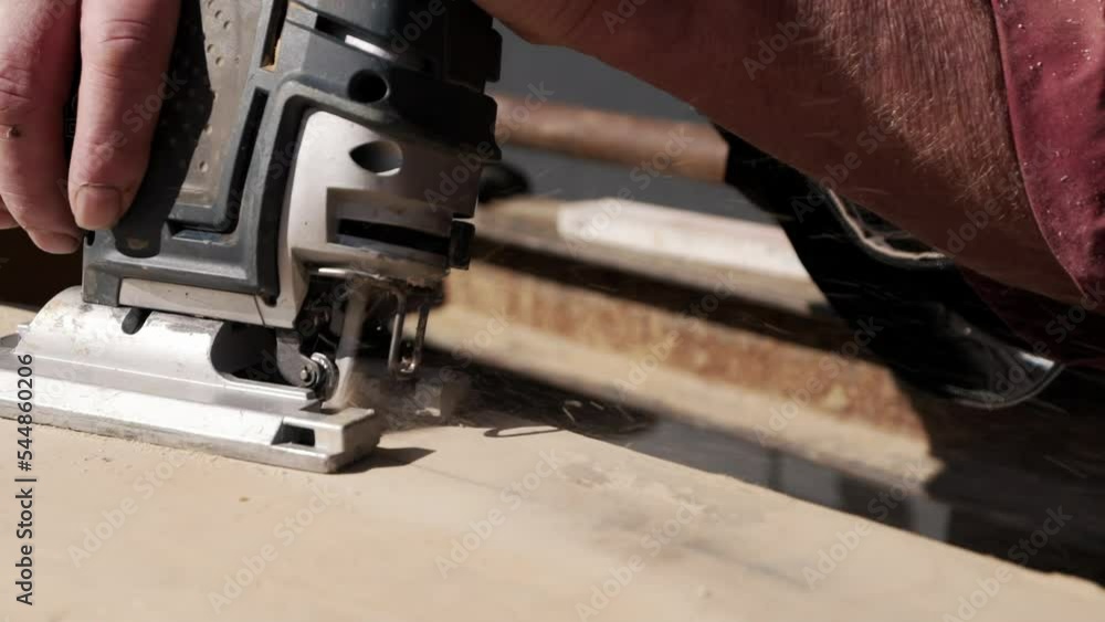 Male Worker Using Jigsaw to Cut Shape out of Wooden Template CLOSE UP Male Worker Using Jigsaw to Cut Shape out of Wooden Template CLOSE UP
