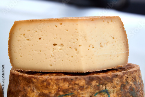 Photo of a handcrafted hard cheese on a village fair. Selective focus