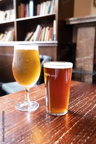 Obraz na plátne Pint glasses of british ale and lager beer served in old vintage English pub