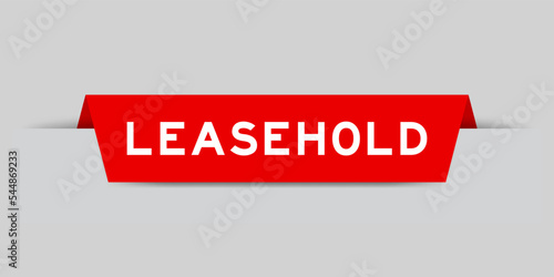 Red color inserted label with word leasehold on gray background