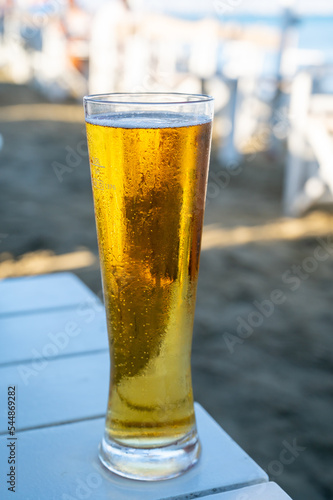 Pint of cold lager beer served in sunny beach bar on Cyprus