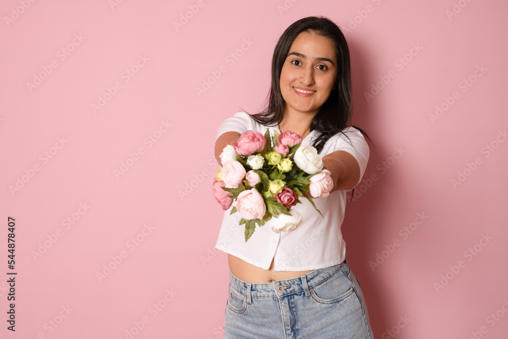 Young beautiful romantic woman with long hair holding bouquet of flowers with a happy and cool smile on face. Lucky person. Young beautiful romantic woman with long hair holding bouquet of flowers with a happy and cool smile on face. Lucky person.