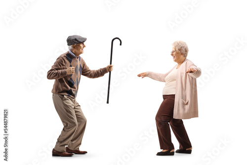 Full length profile shot of an elderly husband and wife dancing