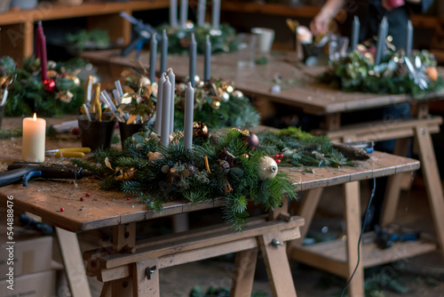 preparing traditional advent wreath with candles, baubles, natural components, pine fir and adorns