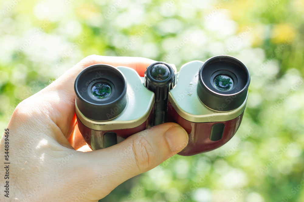 Binoculars in hand. Surveillance of the environment. Binoculars in hand. Surveillance of the environment.