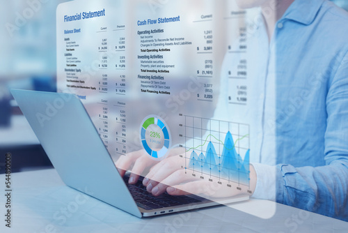 Accountant analysing financial statement with graph on computer. Auditing balance sheet, sales and income report, business operations data, corporate accounts. Finance and consulting. photo