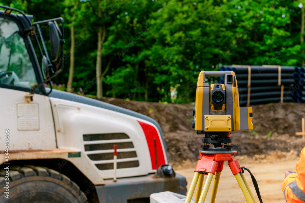 Surveying equipment tacheometer or theodolite set by an engineer during roadworks  at the construction site