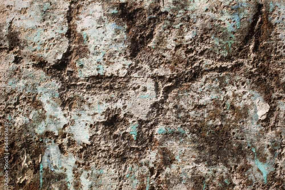 A weathered concrete wall with cracks and peeling paint, showing signs of age and decay. A weathered concrete wall with cracks and peeling paint, showing signs of age and decay.