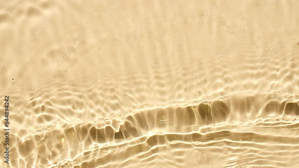 Water with reflections sunlight and shadows. Slow motion of waves water on yellow background. Sun and shadows. Video for design, advertising, products. High quality 4k footage Water with reflections sunlight and shadows. Slow motion of waves water on yellow background. Sun and shadows. Video for design, advertising, products. High quality 4k footage