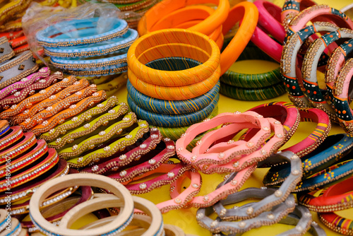 Colorful Bangles display in Shop for women, Metal Bangles Arranged On The Shelf For Sell, Series of bangles. Selective Focus.